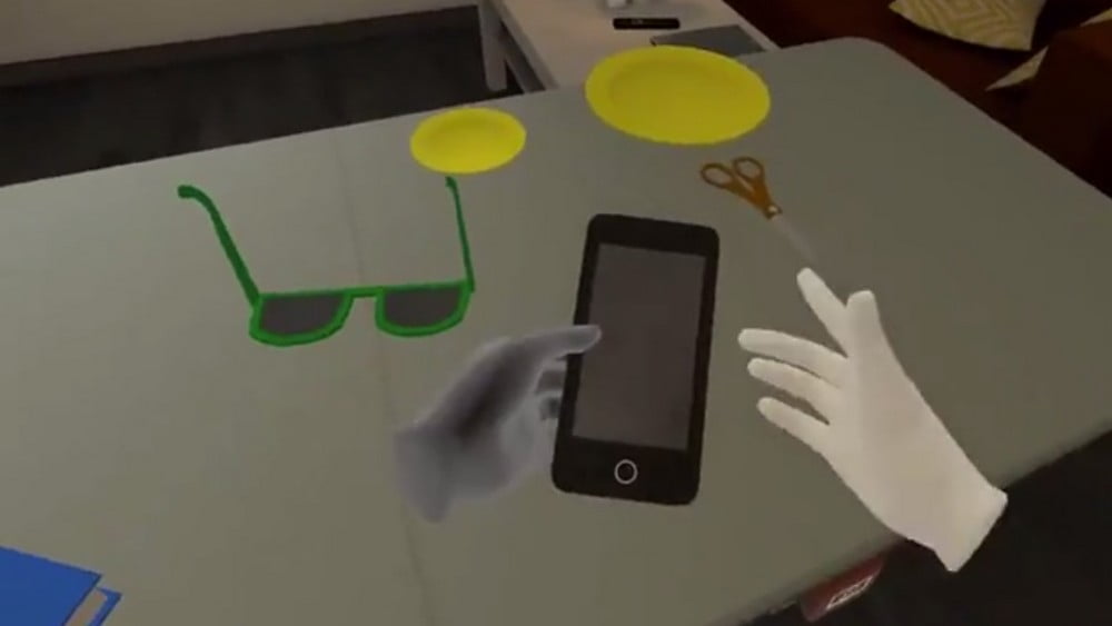 Virtuelle Hände greifen ein virtuelles Smartphone mit korrekten Hand-Posen mittels Quest-Handtracking