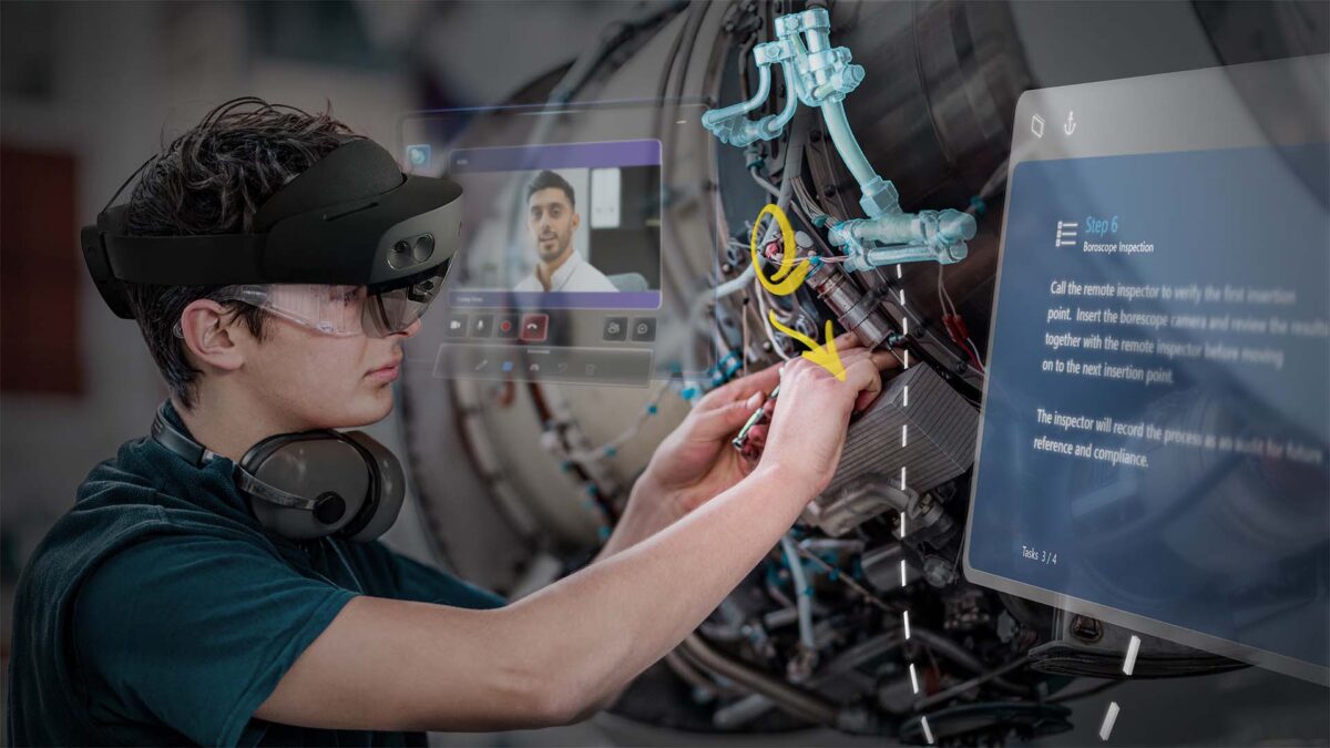Ein Träger der AR-Brille Hololens 2 arbeitet an einer Maschine.