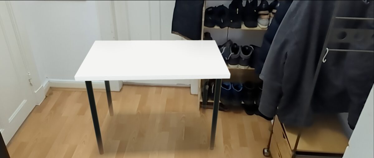 Ein Raum mit einem weißen Ikea-Tisch.