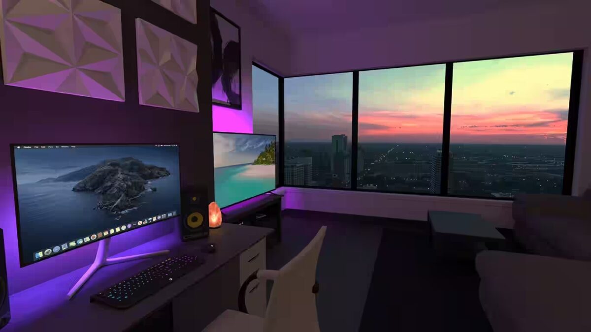 Ein Monitor steht in einem Zimmer. Rechts von dem Monitor befindet sich ein großes Fenster, durch das der Sonnenuntergang zu sehen ist.