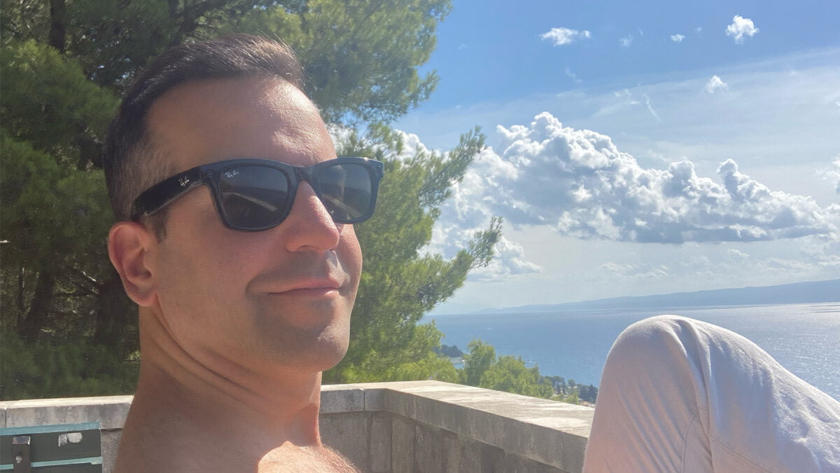 Mann mit Ray-Ban Stories im Hintergrund Meer und Wolken.