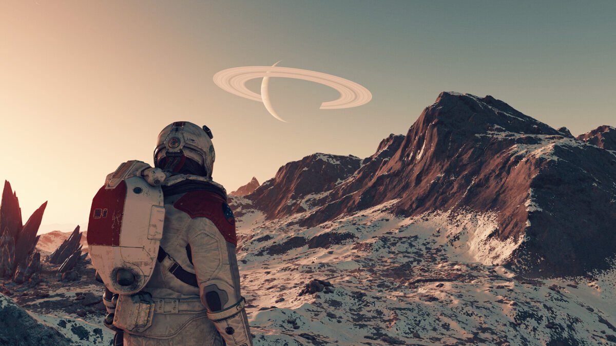 Ein Ausschnitt aus dem Rollenspiel Starfield, in dem ein Astronaut auf einem felsigen Planeten auf ein Gebirge blickt.