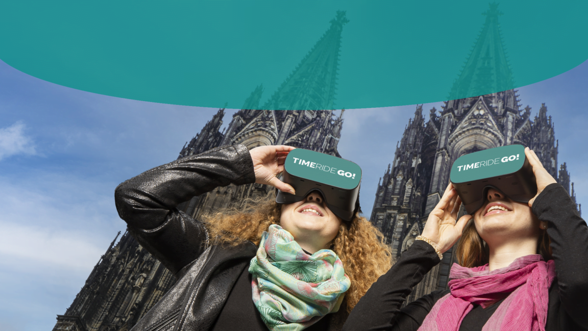 Zwei Frauen mit VR-Brillen vor dem Kölner Dom